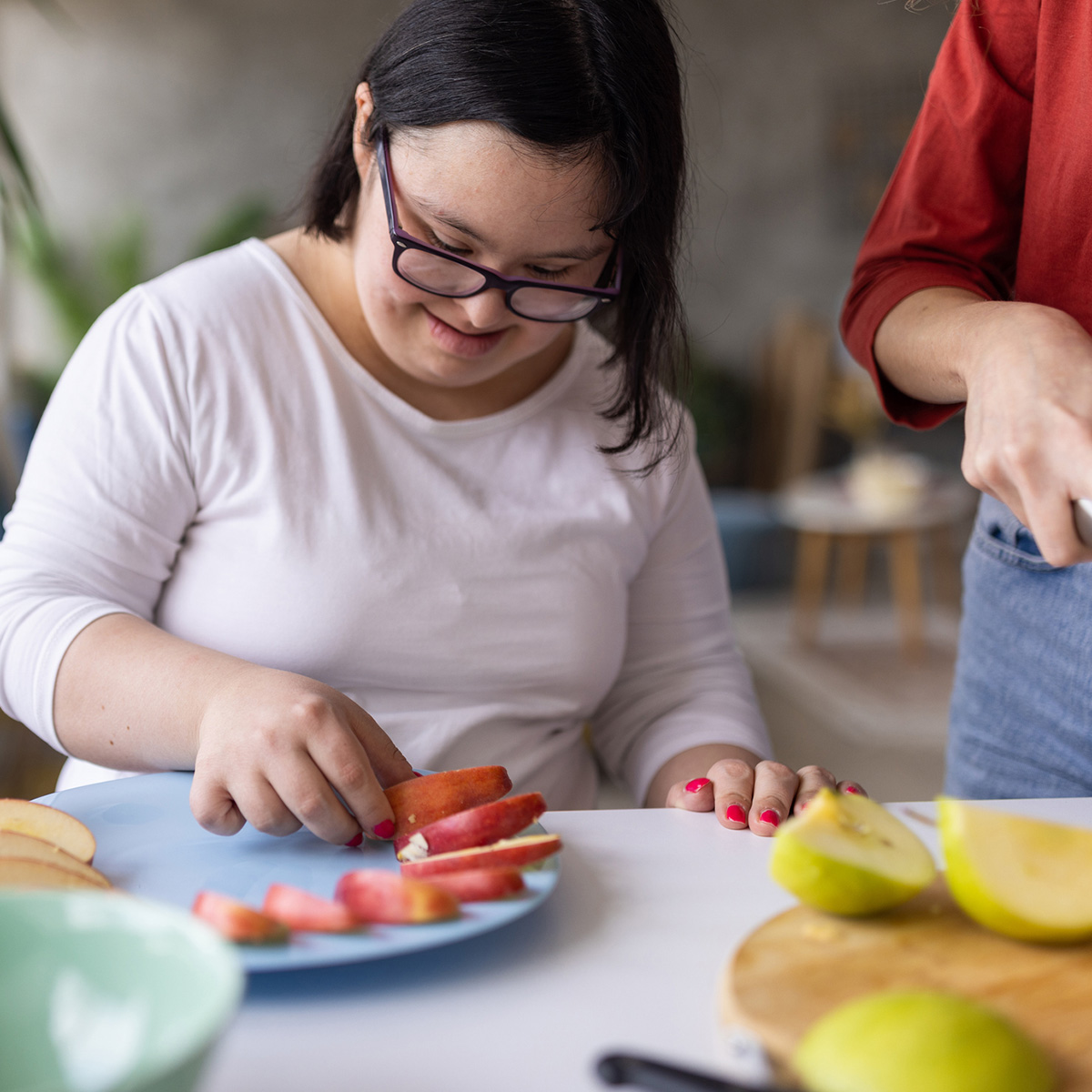 Young woman making a fruit salad